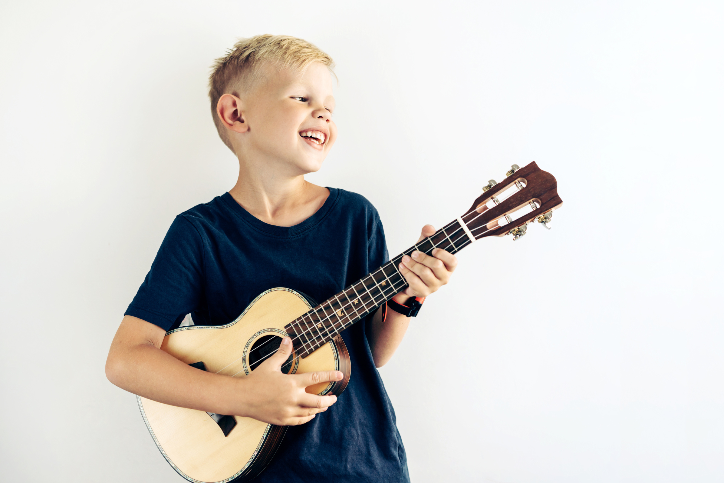 Young Kid Playing a Ukulele